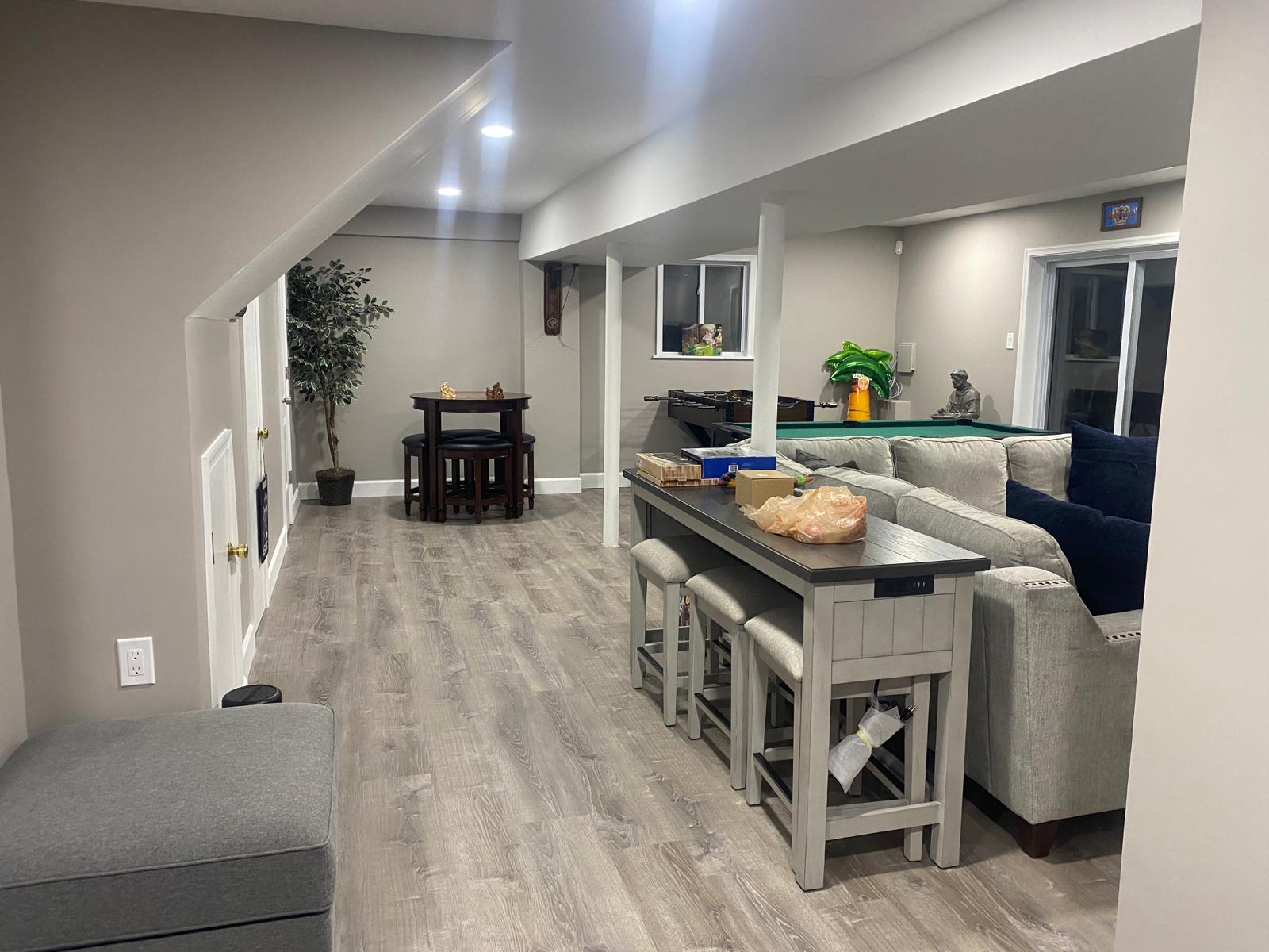 Modern finished basement with game room, pot lights, and LVP flooring