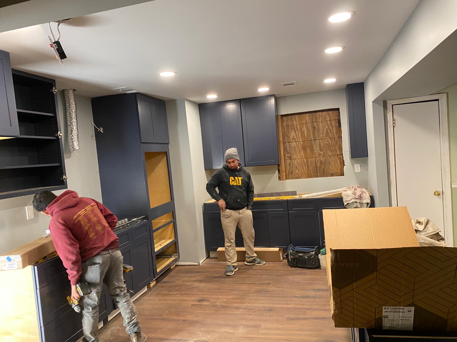 Kitchen under construction with framing and cabinets