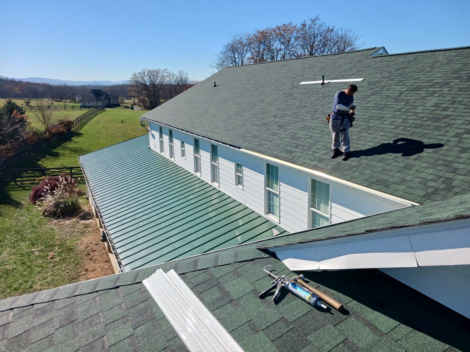Green standing seam metal roof on countryside estate